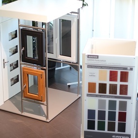 Ausstellung mit modernen Kunststofffenstern, Haustür und Farbmuster für Fensterprofile.